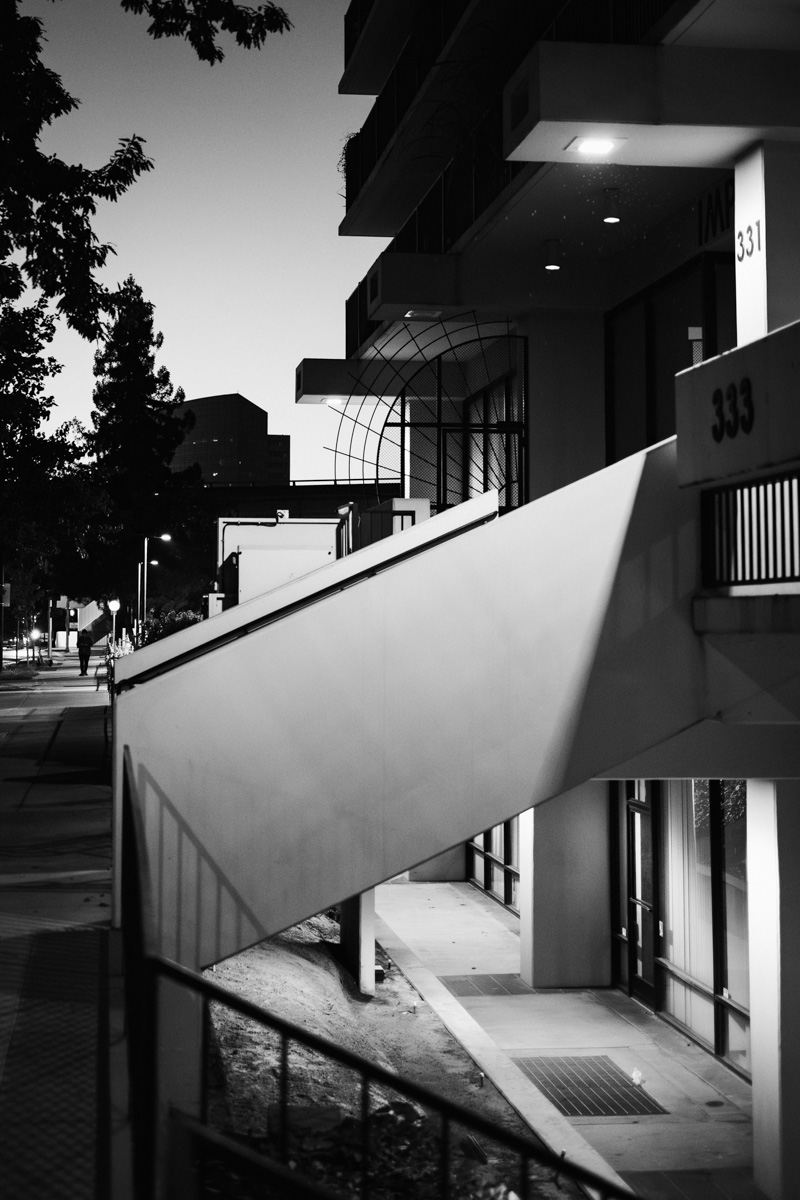 Black and white view of a concrete staircase outside buildings numbered 331 and 333
